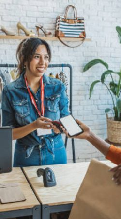 Customer at thrift store making a mobile payment.